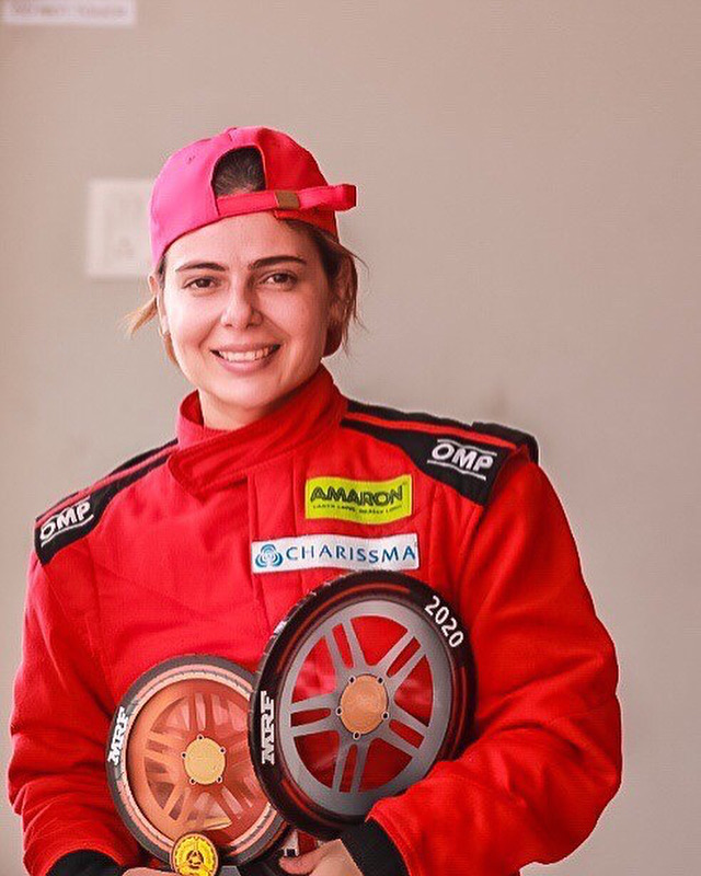 Alisha smiling with 2020 trophies